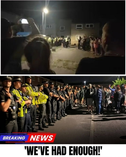 CHAOS IN NORFOLK: Standoff Escalates Outside Asylum Housing! Angry crowds gathered at St. John’s Way demanding the immediate removal of migrants, accusing leaders of betrayal! As tensions boiled over, police formed human shields to protect the complex—until a sudden evacuation plan was leaked… Just as officers moved to secure the building, a shocking action targeted a female officer, forcing riot units to make a split-second decision… See details in the first comment…